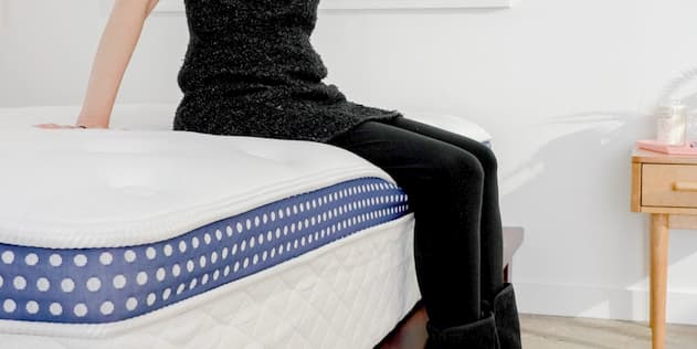 woman sitting on a bed