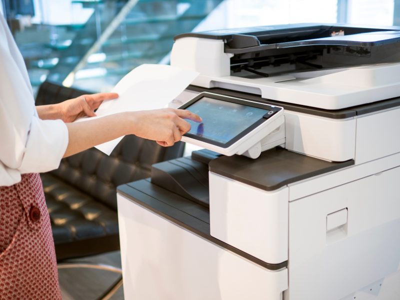 woman printing document in office