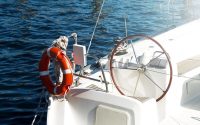 boat sails with lifebuoy ring on the front