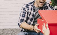 man opening a gift box with beer