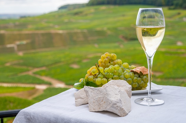photo of chardonnay wine and grapes in nature