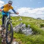 person on the mountain with an electric mountain bicycle